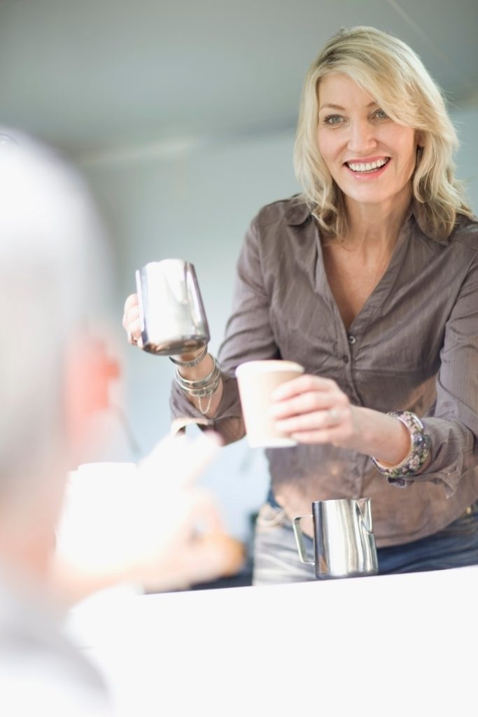 Woman serving coffee in food cart